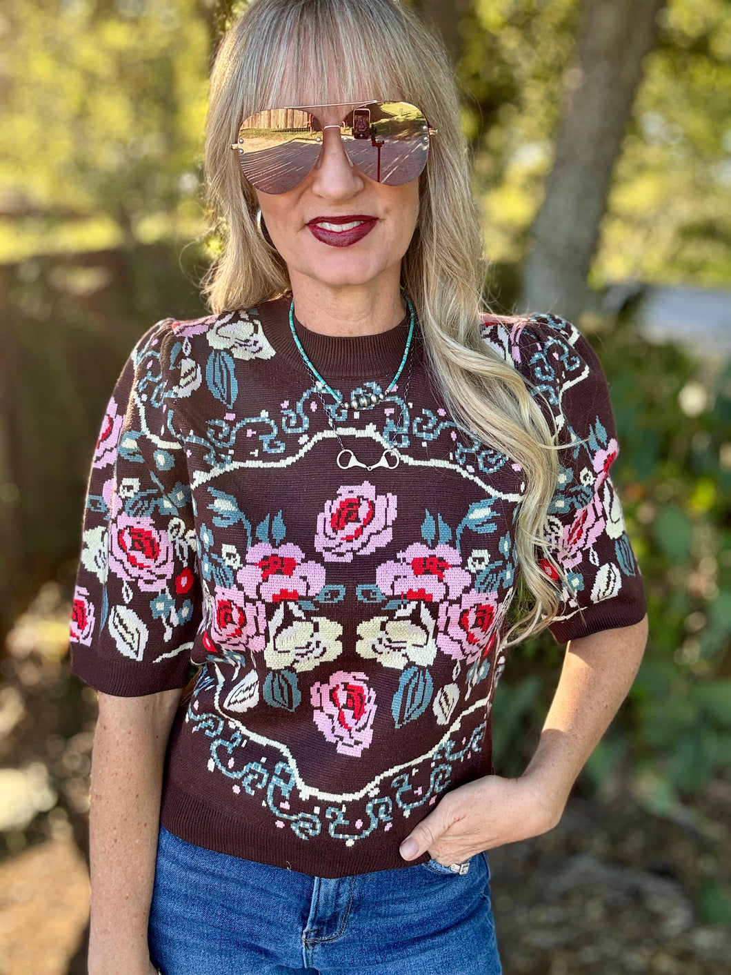 Woman wearing a floral sweater top outdoors