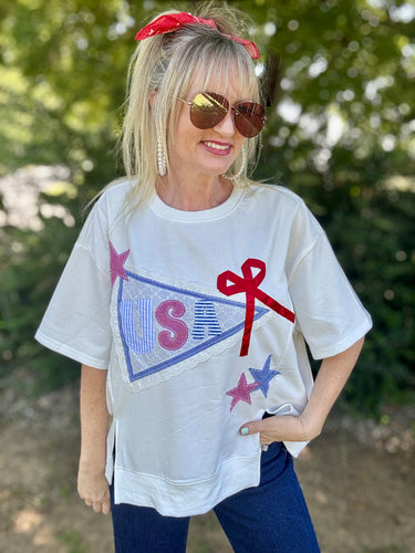Woman wearing a white t-shirt with colorful graphics outdoors