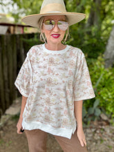 Person wearing a patterned shirt, wide-brimmed hat, and sunglasses outdoors.