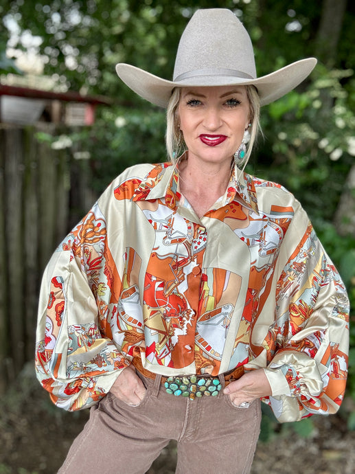 Person wearing a colorful patterned shirt and wide-brimmed hat outdoors.