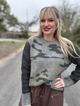 Woman wearing a camouflage sweater outdoors on a road