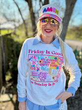 Person wearing a sweatshirt with a colorful design and text, standing outdoors.