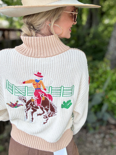 Person wearing a sweater with a rodeo design outdoors
