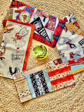 Collection of colorful fabric scarves on a textured surface