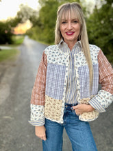 Woman wearing a patchwork jacket with a blurred background