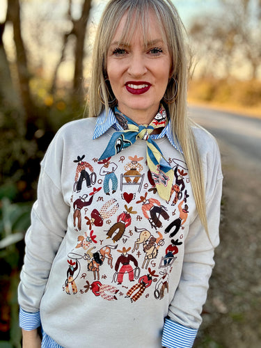 Woman wearing a patterned sweater and colorful scarf outdoors