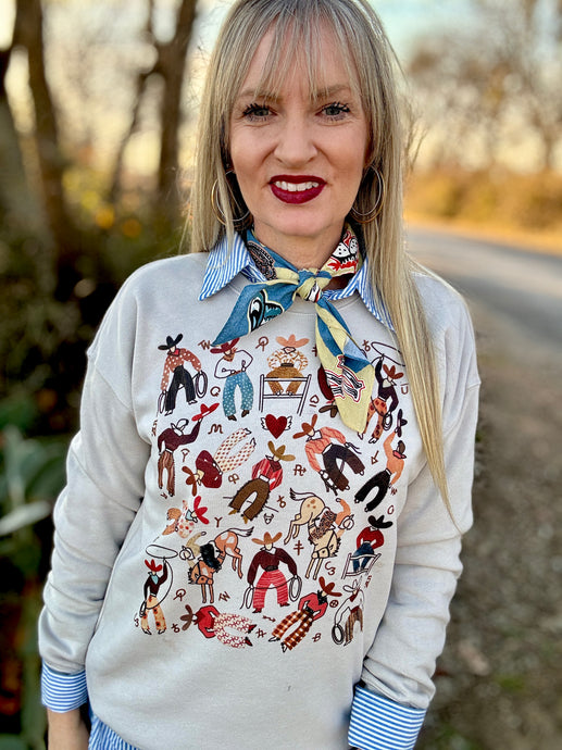 Woman wearing a patterned sweater and colorful scarf outdoors