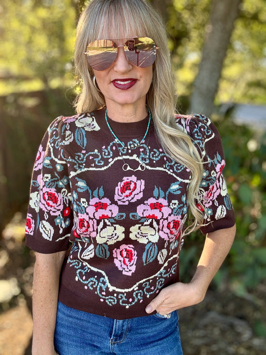 Woman wearing a floral sweater top outdoors