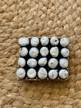 The pistol pearl buckle