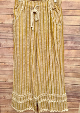 Striped pants with a drawstring on a wooden background